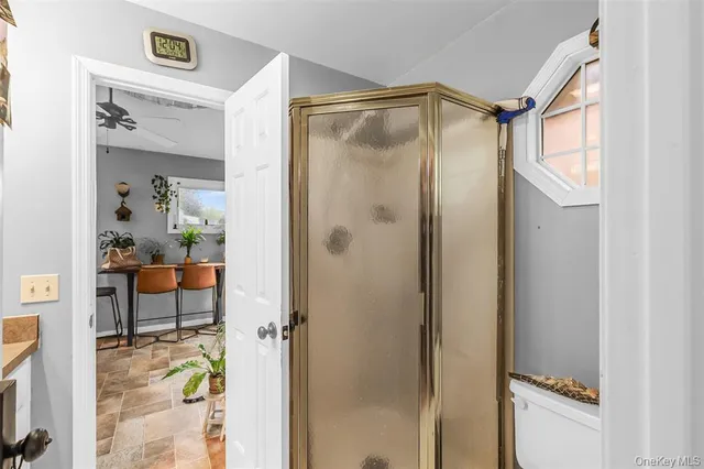 a bathroom with a shower and a mirror