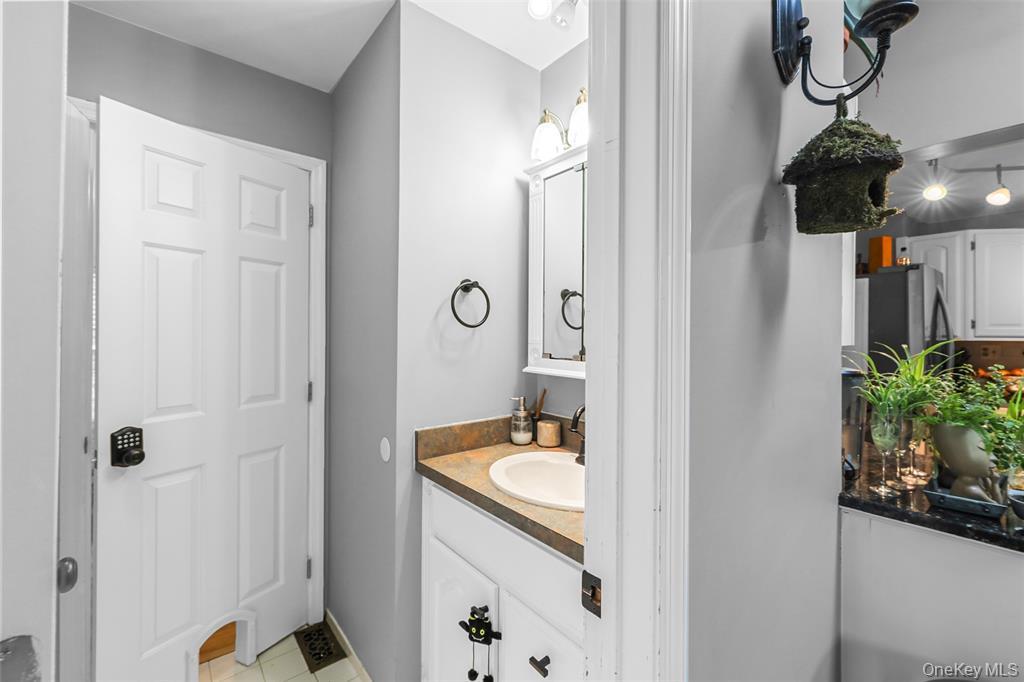 46 Quaker Hill Road Monroe, NY 10950 - Photo 26 of 33 Half bathroom with vanity and light tile patterned flooring
