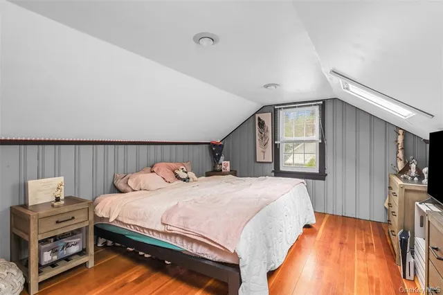 a bedroom with a bed next to a window with outer view