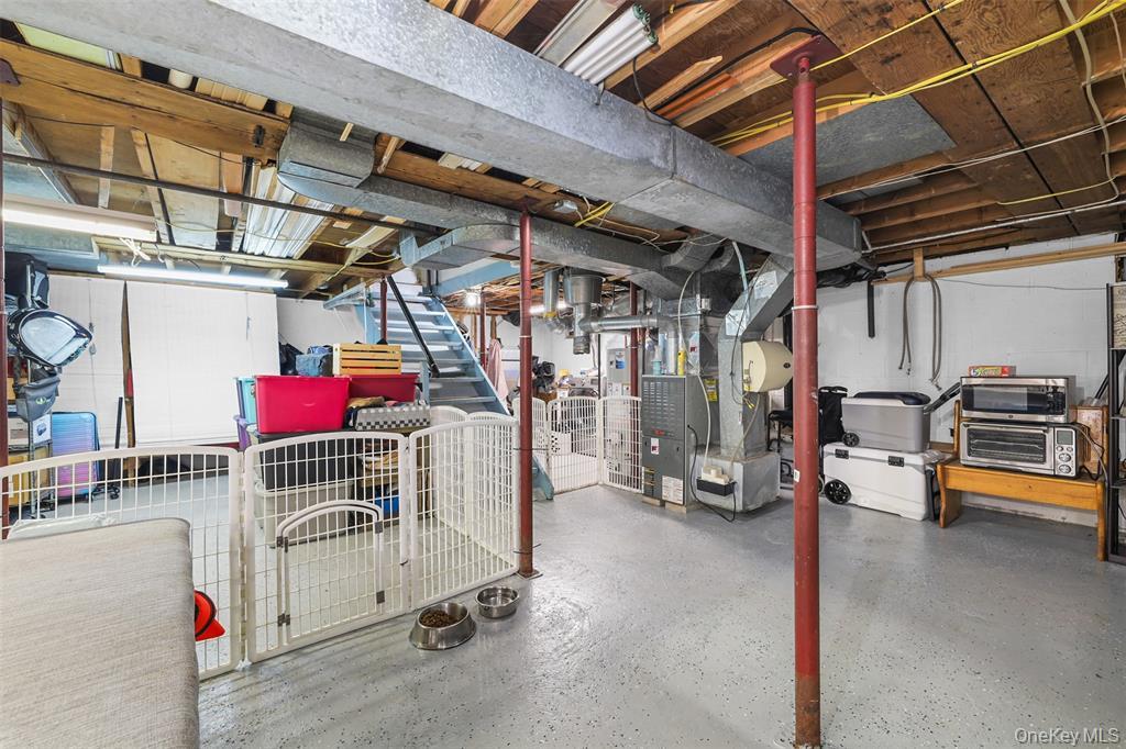 46 Quaker Hill Road Monroe, NY 10950 - Photo 30 of 33 Unfinished basement featuring stairs and heating unit