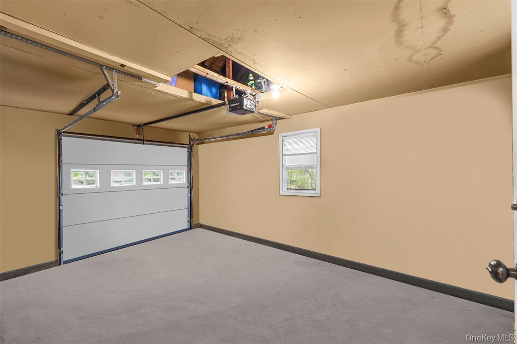 46 Quaker Hill Road Monroe, NY 10950 - Photo 33 of 33 Garage with baseboards and a garage door opener