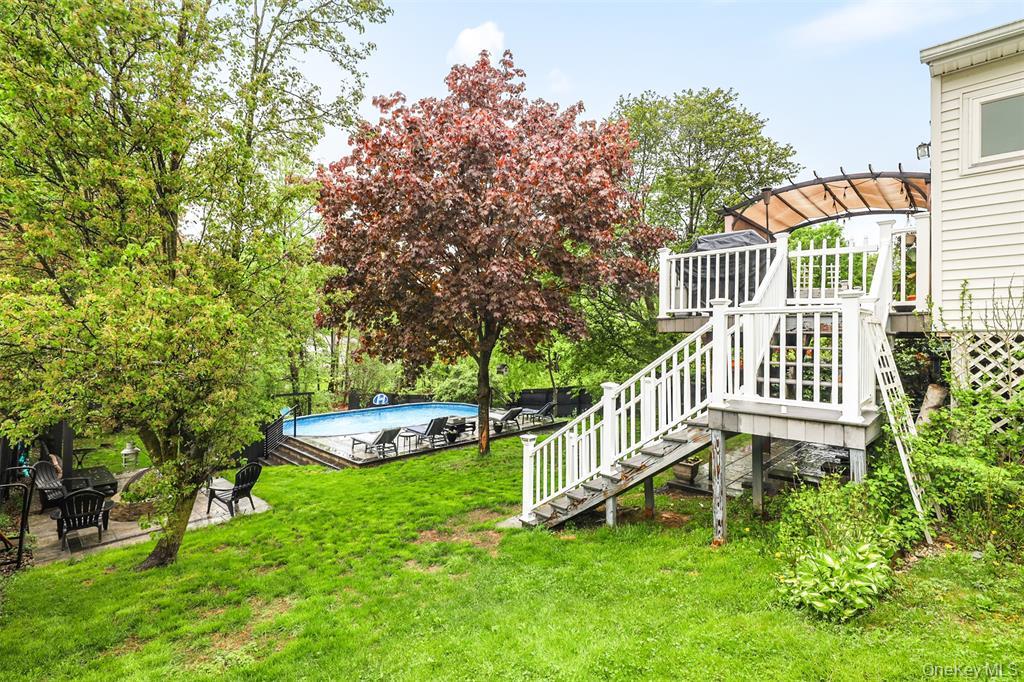 46 Quaker Hill Road Monroe, NY 10950 - Photo 4 of 33 View of green lawn with a deck, stairway, an outdoor pool, and a patio
