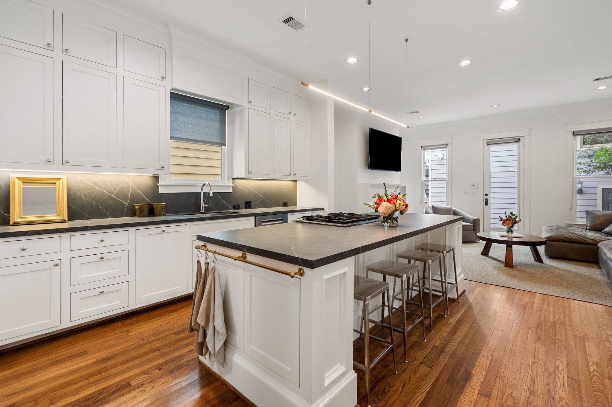 908 East 26th Street Houston, TX 77009 - Photo 9 of 30 The modern, updated kitchen has a large center island, and opens to the living room. The cabinets carry all the way to the ceiling, providing ample storage.