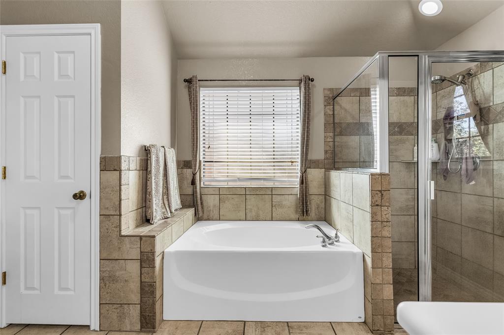 226 King George Road Ponder, TX 76259 - Photo 29 of 39 Full bathroom with a garden tub, a shower stall, and tile patterned flooring