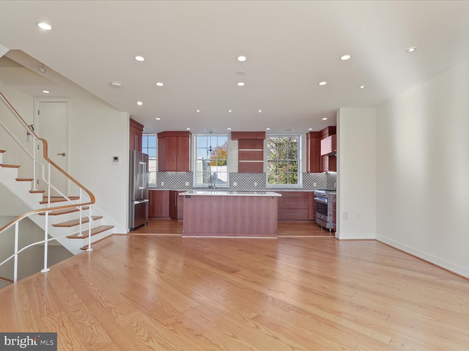 3604 Prospect Street Northwest Washington, DC 20007 - Photo 24 of 70 a large kitchen with stainless steel appliances a large counter top a oven and a wooden floors