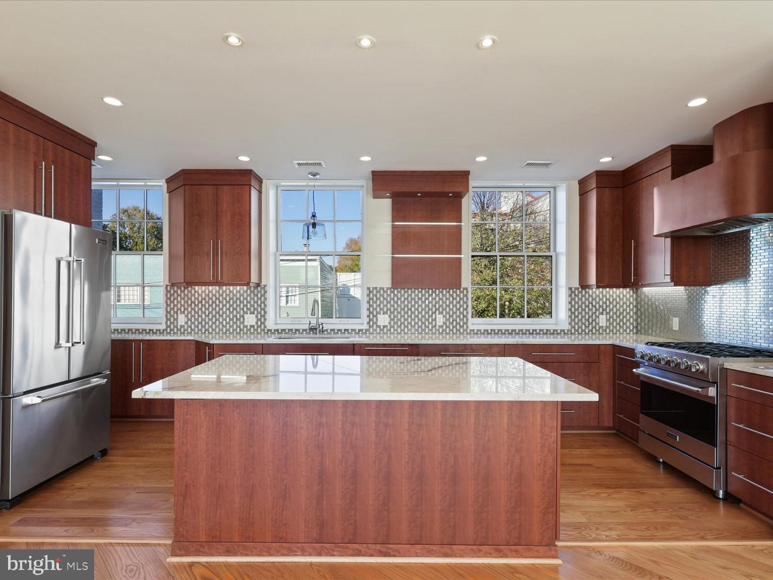3604 Prospect Street Northwest Washington, DC 20007 - Photo 26 of 70 a kitchen with stainless steel appliances granite countertop a sink a stove and a refrigerator