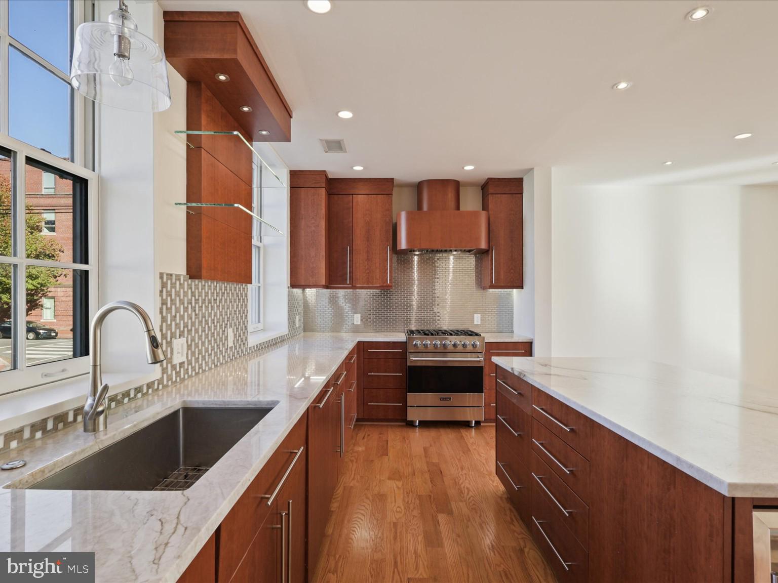 3604 Prospect Street Northwest Washington, DC 20007 - Photo 28 of 70 a kitchen with stainless steel appliances granite countertop a sink stove and cabinets