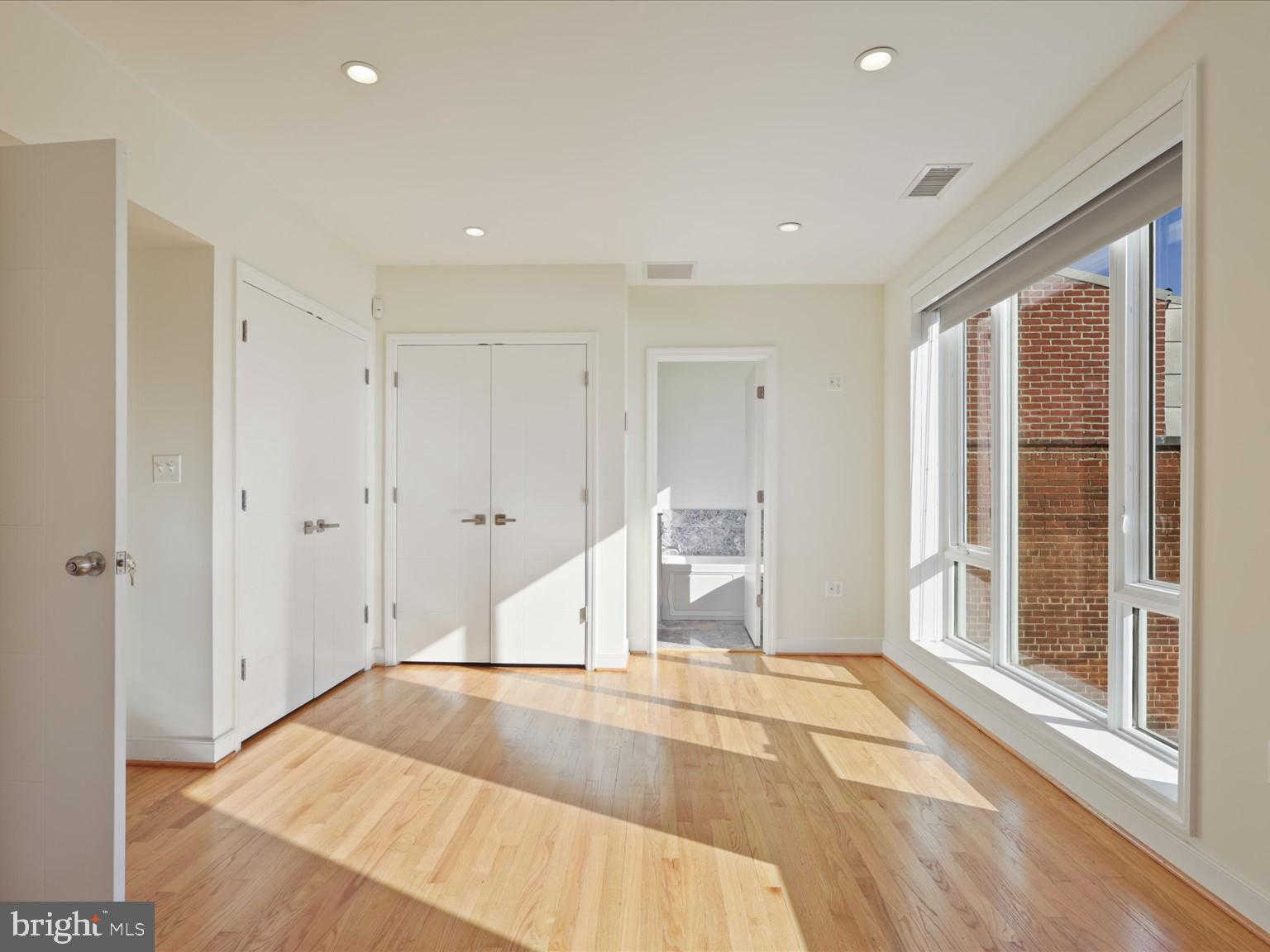 3604 Prospect Street Northwest Washington, DC 20007 - Photo 35 of 70 a view of empty room with wooden floor and fan