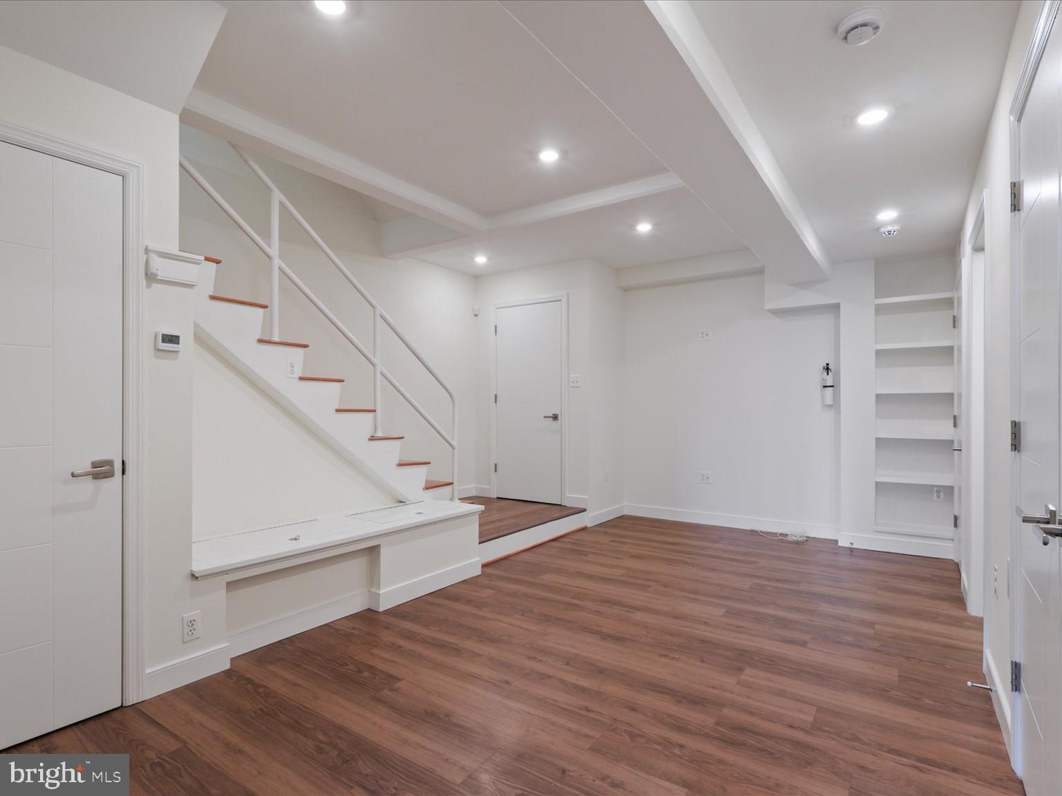 3604 Prospect Street Northwest Washington, DC 20007 - Photo 48 of 70 a view of an empty room with wooden floor and stairs