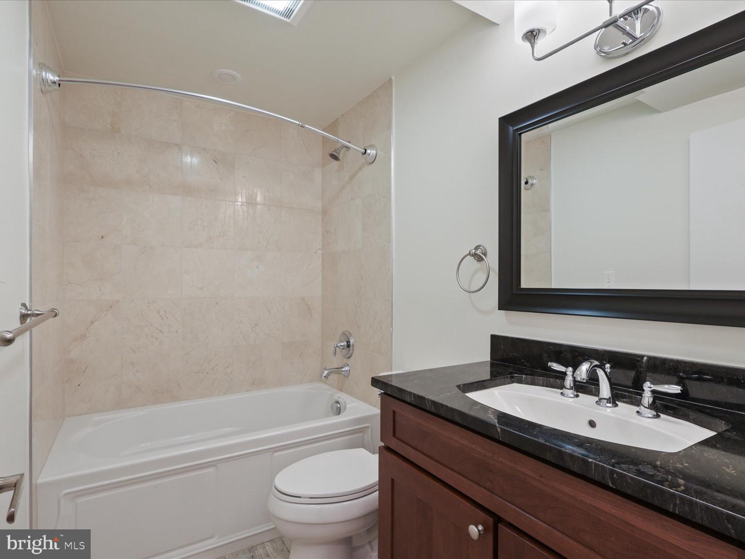 3604 Prospect Street Northwest Washington, DC 20007 - Photo 49 of 70 a bathroom with a granite countertop sink toilet and shower