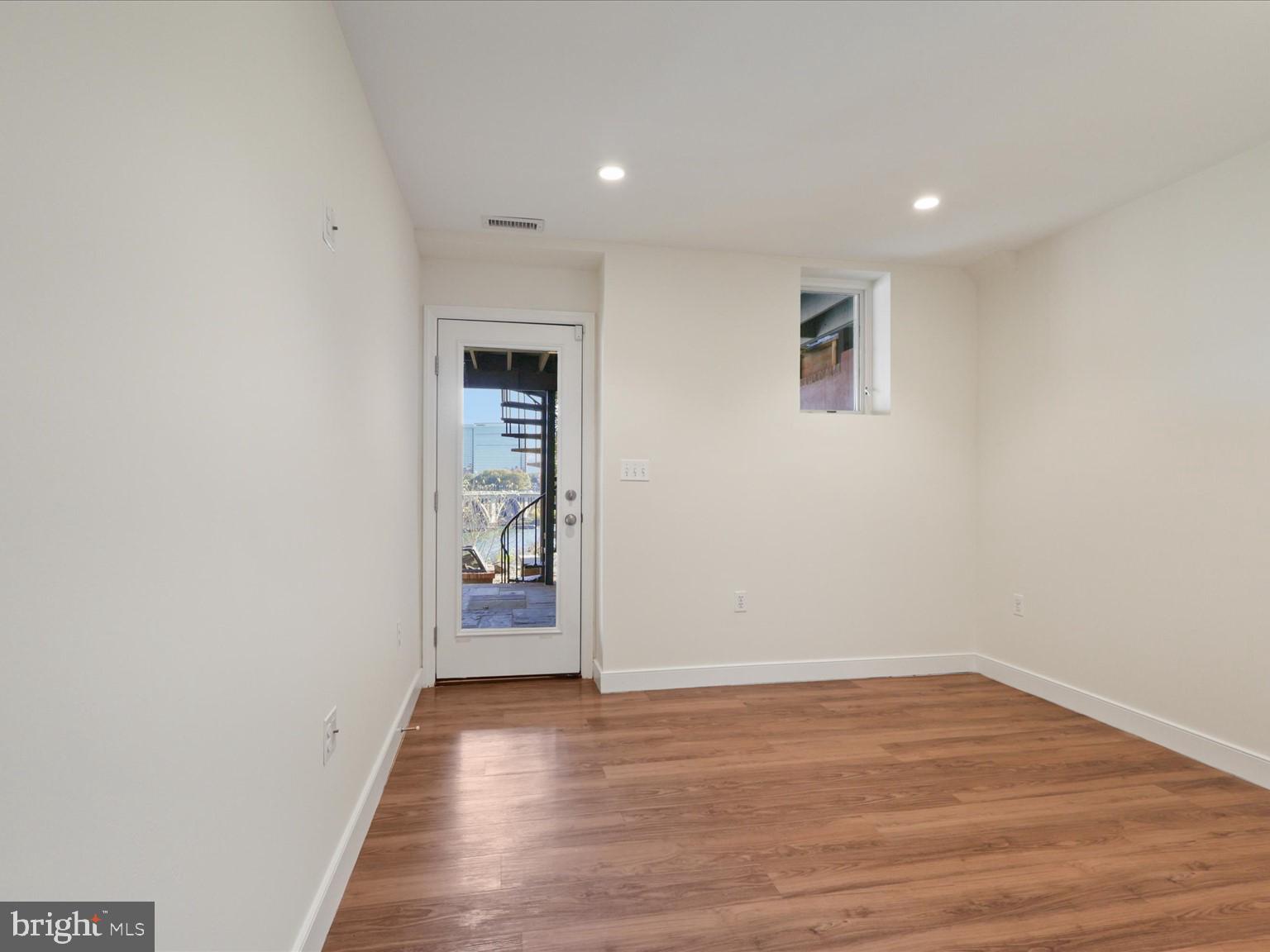 3604 Prospect Street Northwest Washington, DC 20007 - Photo 50 of 70 an empty room with wooden floor and door