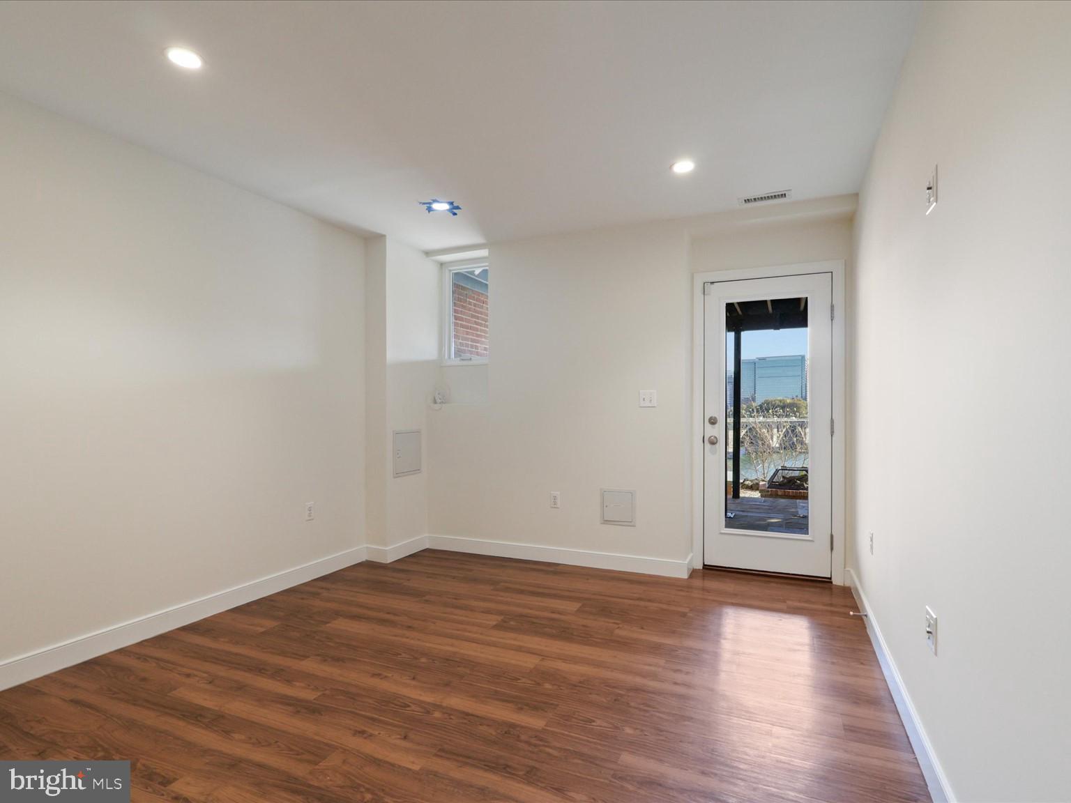 3604 Prospect Street Northwest Washington, DC 20007 - Photo 51 of 70 wooden floor in an empty room with a window
