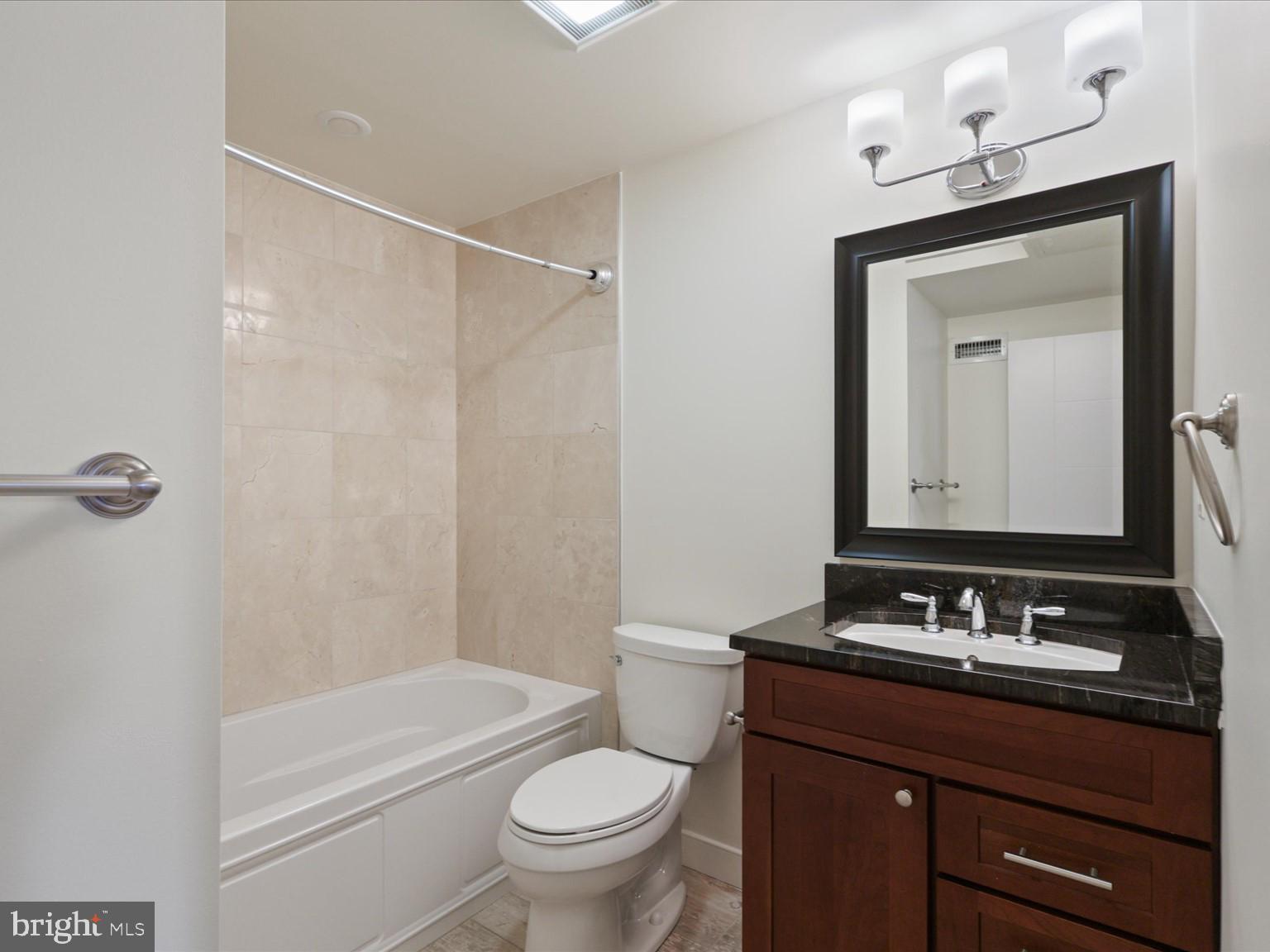 3604 Prospect Street Northwest Washington, DC 20007 - Photo 53 of 70 a bathroom with a granite countertop sink toilet a mirror and shower