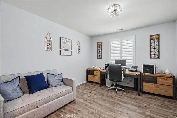 a view of a livingroom with workspace and a couch