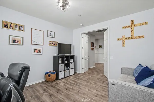 a bedroom with furniture and a flat screen tv