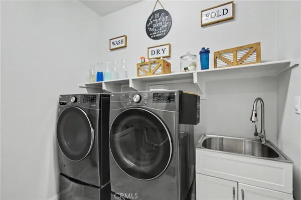 a view of storage and utility room with washer and dryer