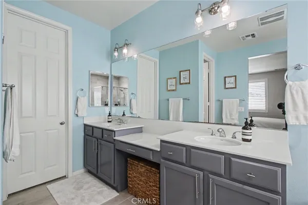 a bathroom with a sink double vanity and a mirror