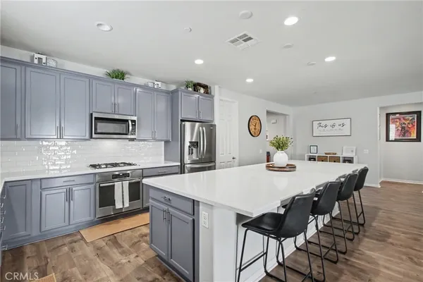 a large kitchen with a table and chairs