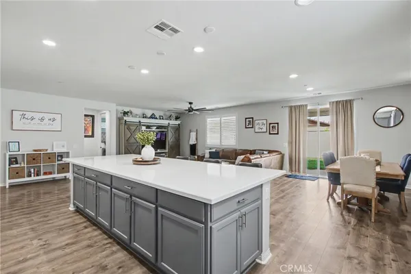 a large white kitchen with a large island in the center