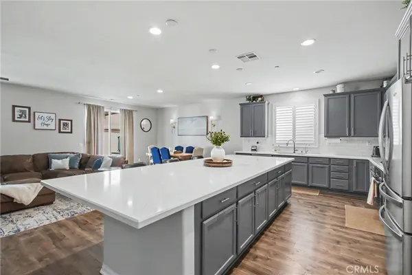 a large kitchen with kitchen island a sink counter space and stainless steel appliances