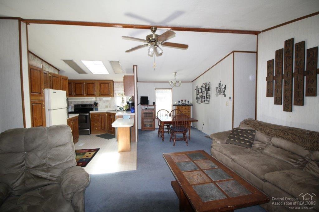 19235 Kiowa Road Bend, OR 97702 - Photo 2 of 25 a living room with furniture kitchen view and a chandelier