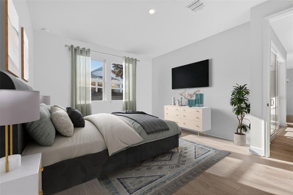 983 Fiesta Key Circle Lady Lake, FL 32159 - Photo 15 of 39 a bedroom with a bed and a flat screen tv