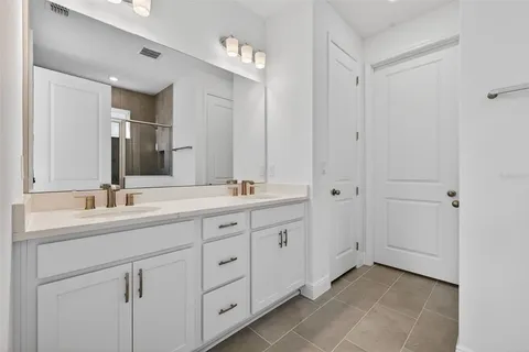 a bathroom with a double vanity sink and mirror