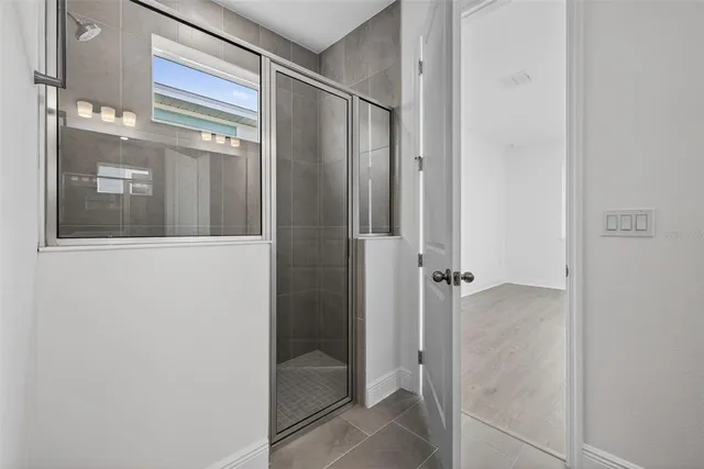 a bathroom with a glass shower door