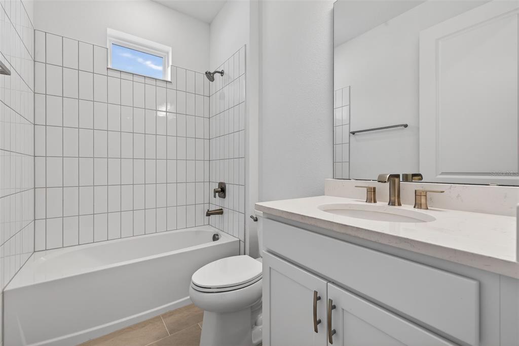 983 Fiesta Key Circle Lady Lake, FL 32159 - Photo 23 of 39 a bathroom with a sink a toilet and shower