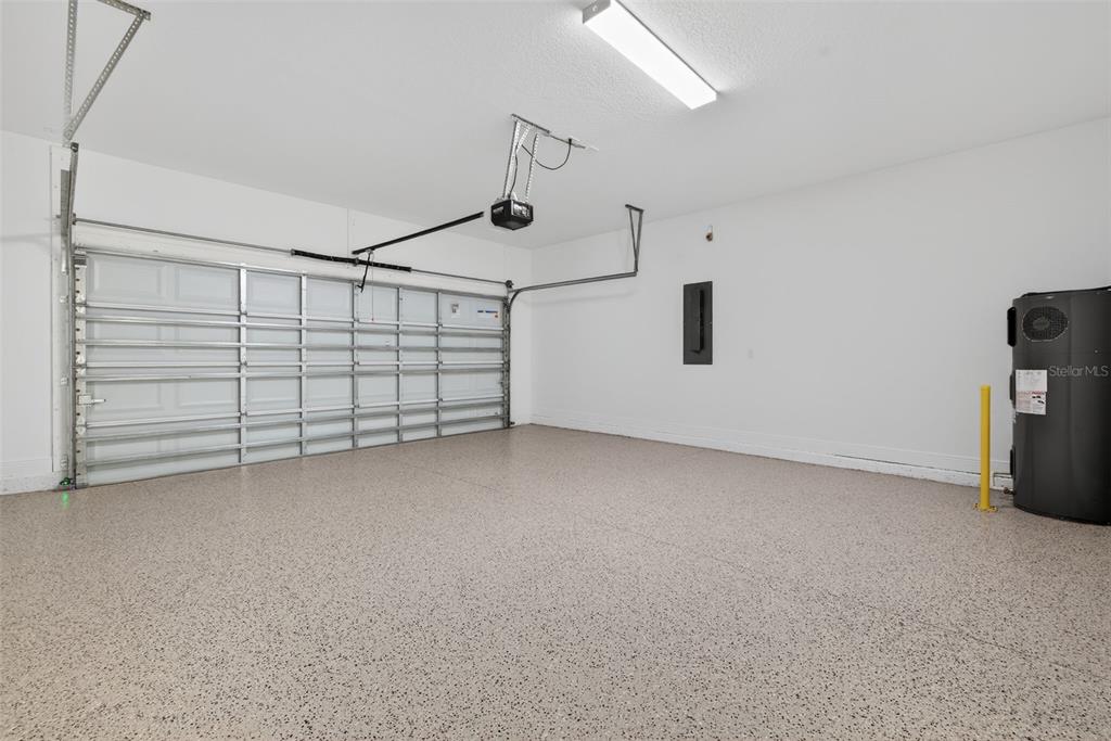 983 Fiesta Key Circle Lady Lake, FL 32159 - Photo 27 of 39 a view of a garage with racks on the wall