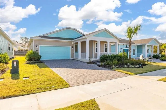 an aerial view of a city with lots of residential buildings and ocean view