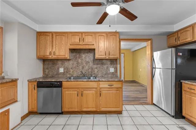 a kitchen with a refrigerator and a sink