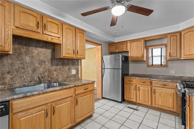 a kitchen with cabinets stainless steel appliances and a counter space