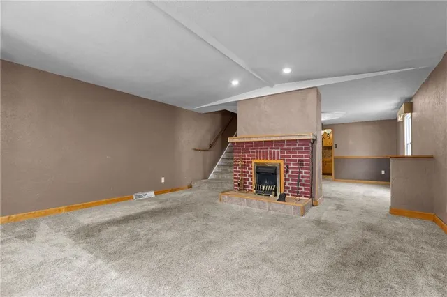a view of an empty room with a fireplace