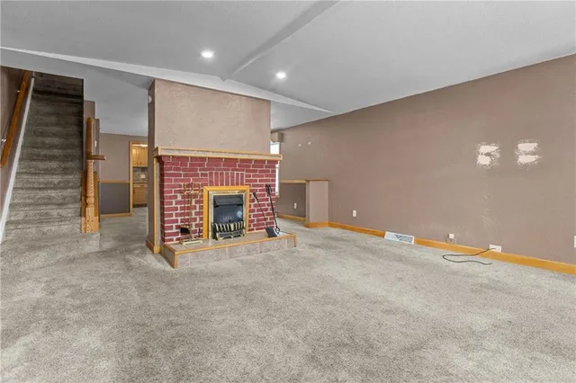 a view of an empty room with a fireplace
