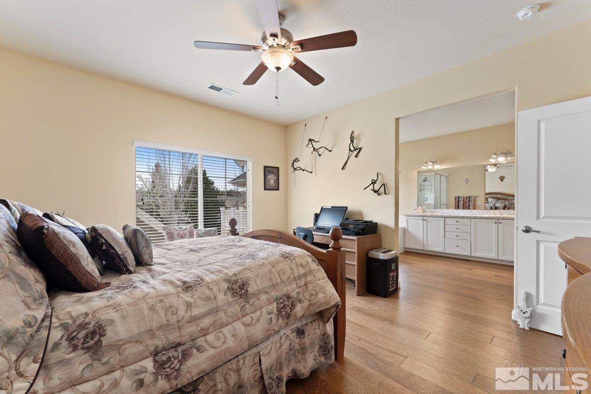 3240 Paragon Place Reno, NV 89509 - Photo 11 of 17 a bedroom with a bed and glass walk in closet