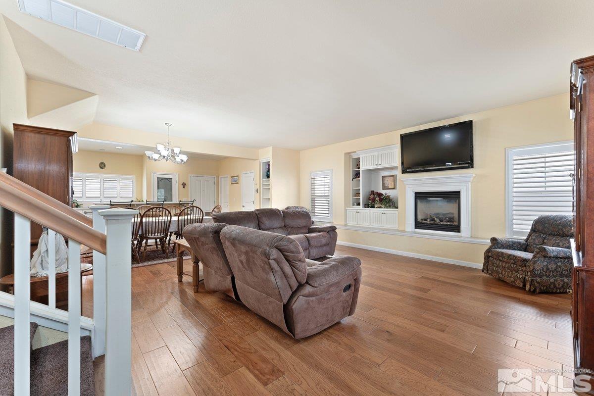 3240 Paragon Place Reno, NV 89509 - Photo 5 of 17 a living room with furniture a flat screen tv and a fireplace