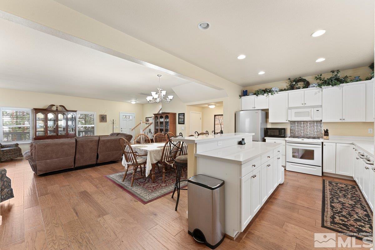 3240 Paragon Place Reno, NV 89509 - Photo 7 of 17 a large white kitchen with lots of counter space a sink appliances and cabinets