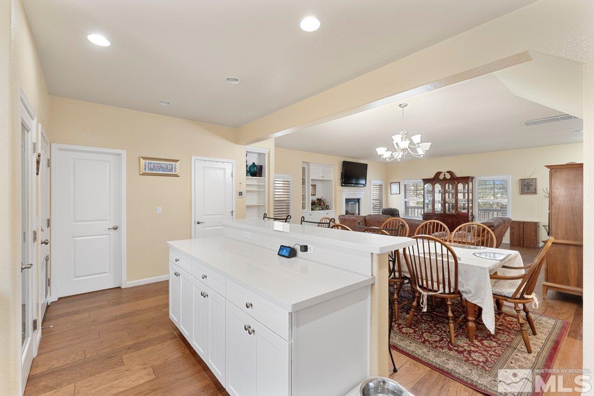 3240 Paragon Place Reno, NV 89509 - Photo 8 of 17 a large white kitchen with a large counter top furniture and a dining table