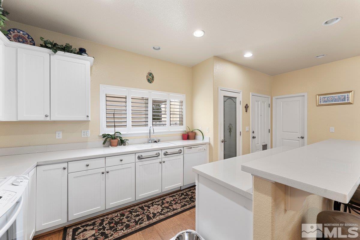 3240 Paragon Place Reno, NV 89509 - Photo 10 of 17 a large white kitchen with a sink and cabinets