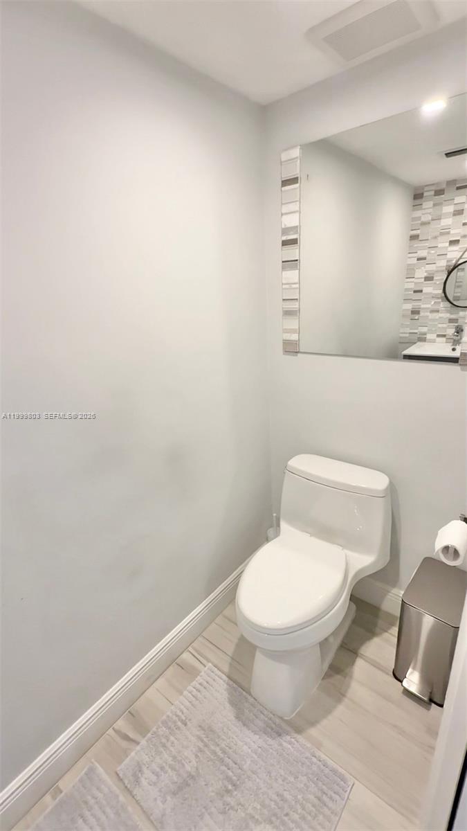 6728 Boca Pines Trail, Unit B Boca Raton, FL 33433 - Photo 13 of 30 a white toilet sitting next to a bathroom sink