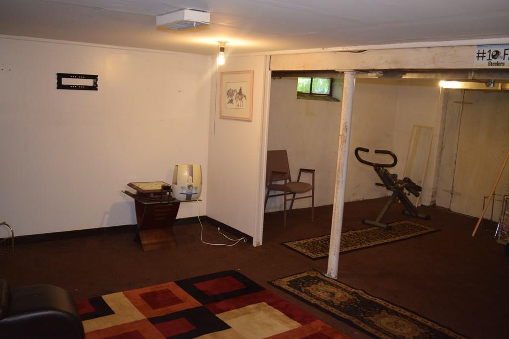 182 Merrimac Avenue Springfield, MA 01104 - Photo 12 of 18 a view of a workspace with furniture and gym equipment