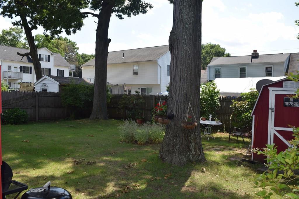 182 Merrimac Avenue Springfield, MA 01104 - Photo 4 of 18 a backyard of a house with lots of green space