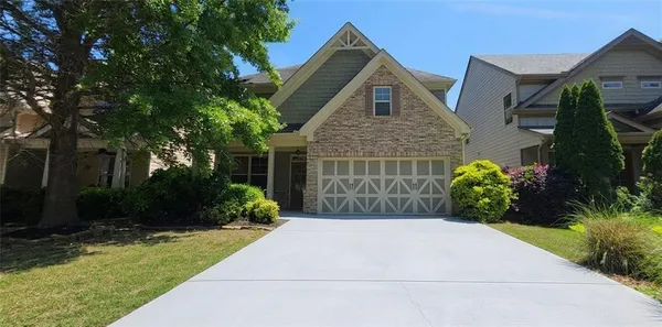 a front view of a house with garden