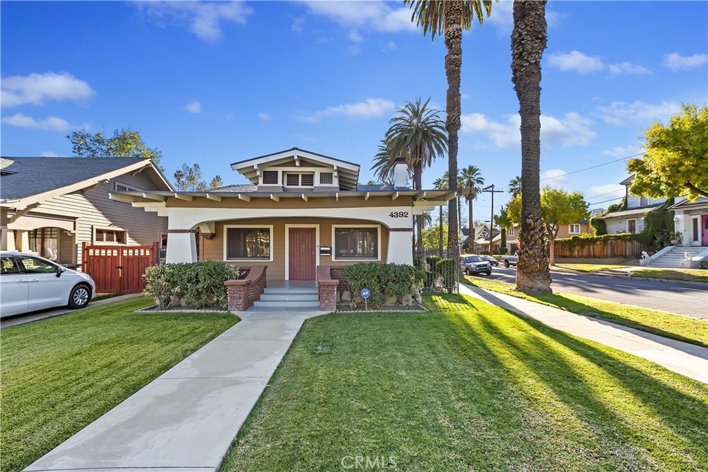 4392 University Avenue Riverside, CA 92501 - Photo 1 of 1 a front view of a house with a yard table and chairs