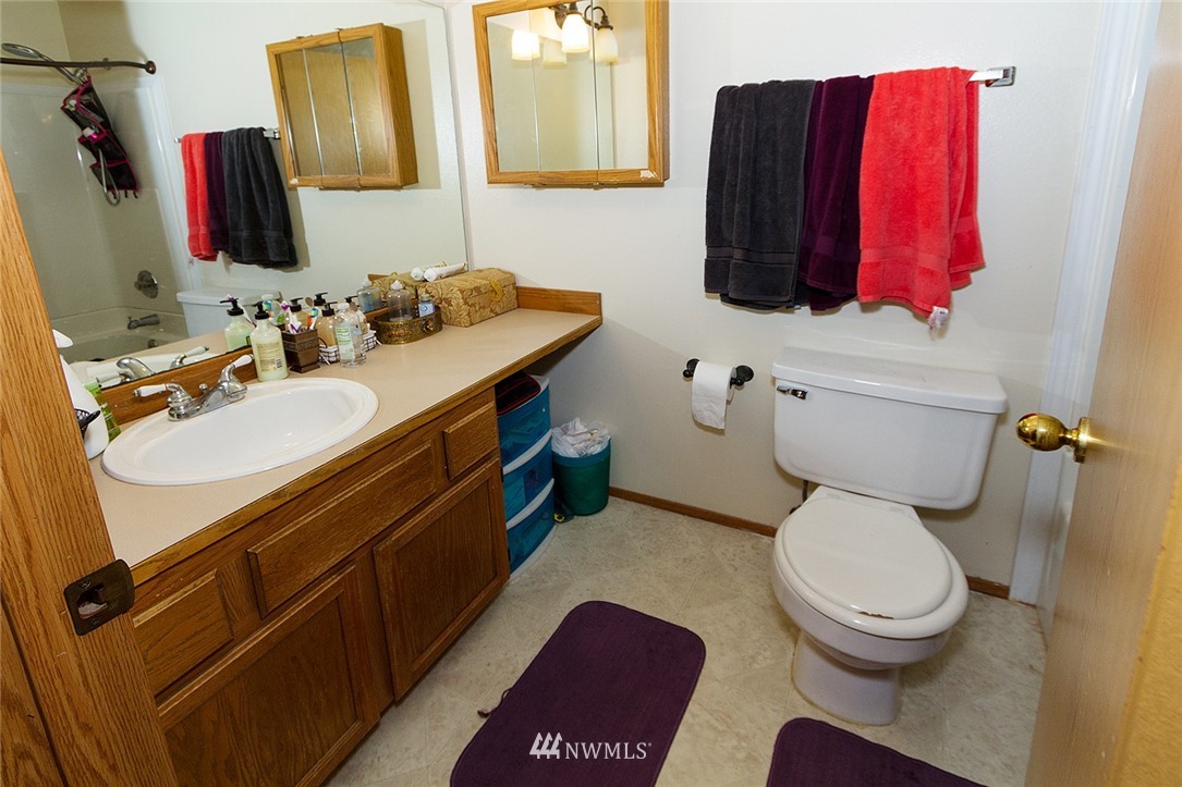 531 Duchess Road Bothell, WA 98012 - Photo 9 of 25 a bathroom with a toilet sink and mirror