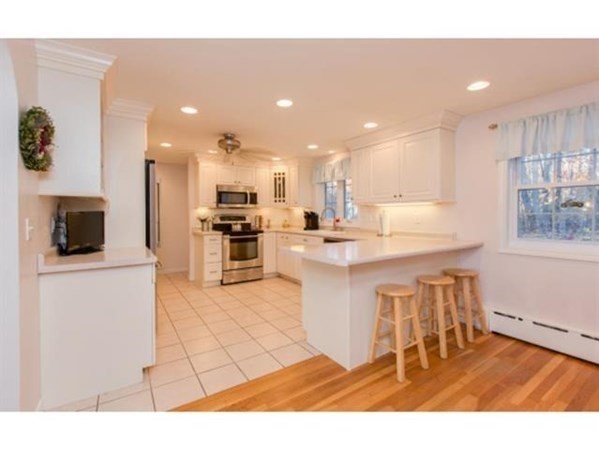 3 McLain Drive Pelham, NH 03076 - Photo 4 of 34 a open kitchen with kitchen island a sink a stove a microwave and a refrigerator