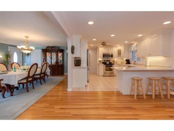 3 McLain Drive Pelham, NH 03076 - Photo 8 of 34 a living room with stainless steel appliances kitchen island granite countertop furniture and a kitchen view