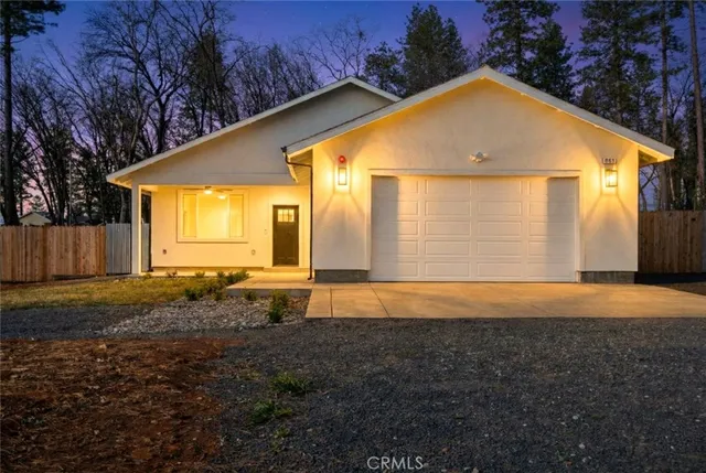 a view of yellow house with a yard