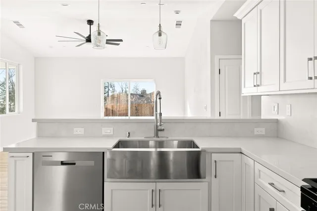 a kitchen with a sink cabinets and window